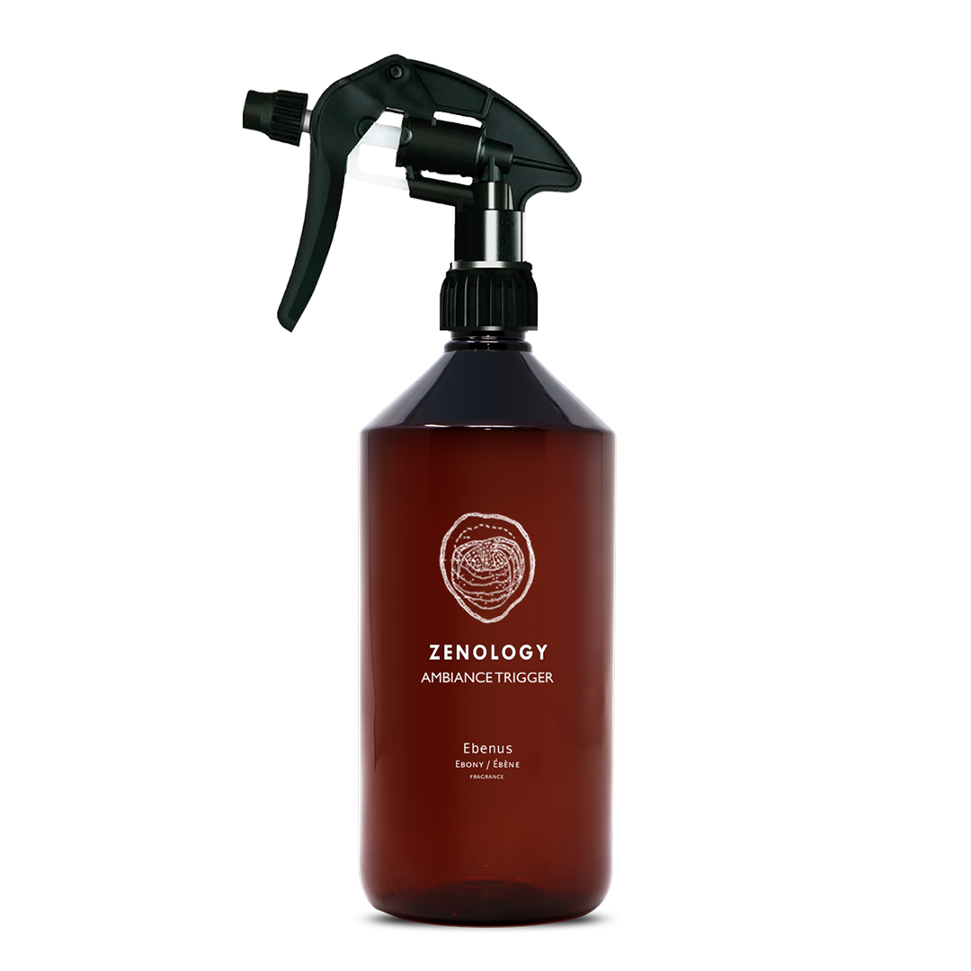 A large sized brown spray bottle labeled Zenology Ambiance Trigger Ebenus featuring an unique botanical illustration with a black spray nozzle.