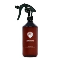 A large sized brown spray bottle labeled Zenology Ambiance Trigger Gossypium featuring an unique botanical illustration with a black spray nozzle.