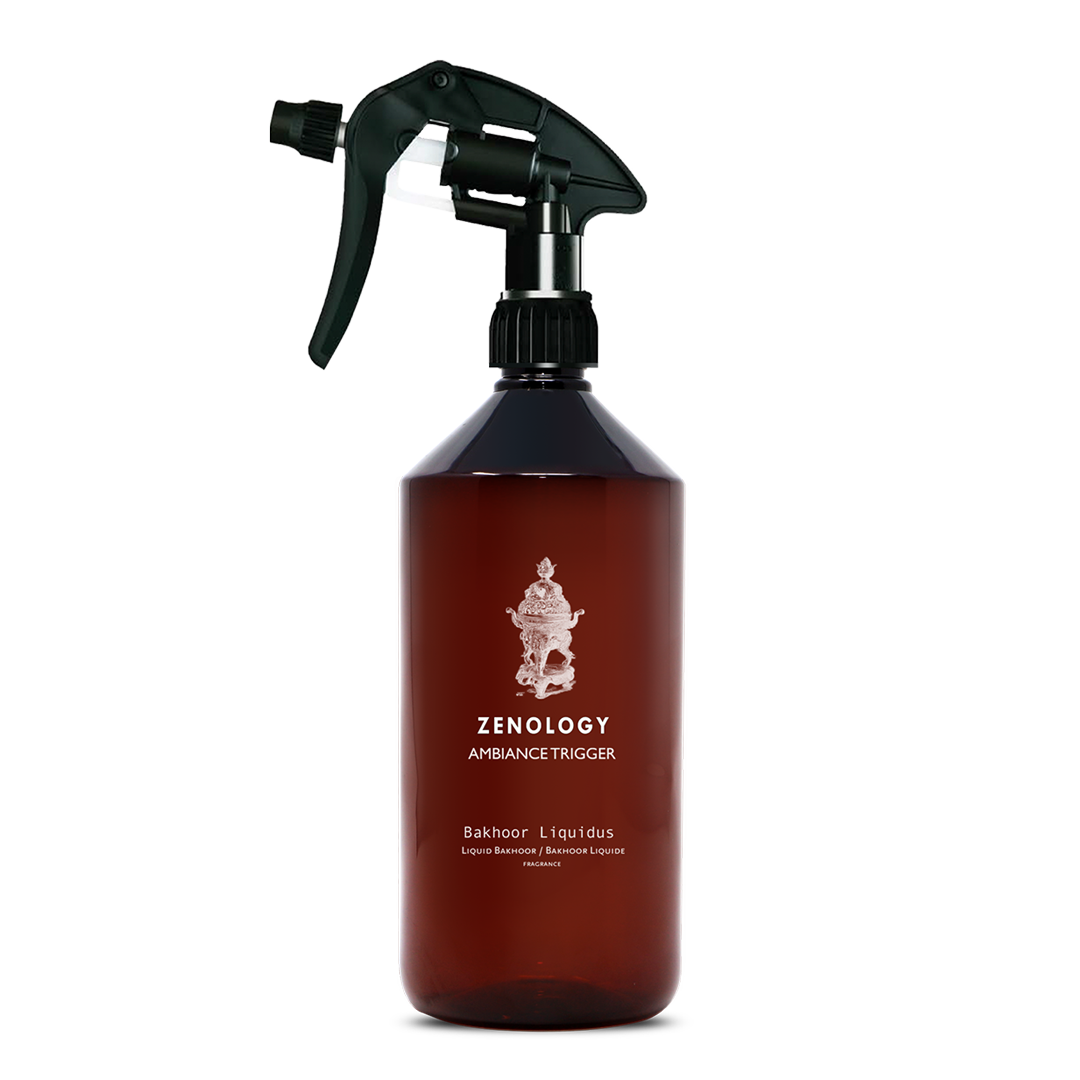 A large sized brown spray bottle labeled Zenology Ambiance Trigger Bakhoor Liquidus featuring an unique botanical illustration with a black spray nozzle.