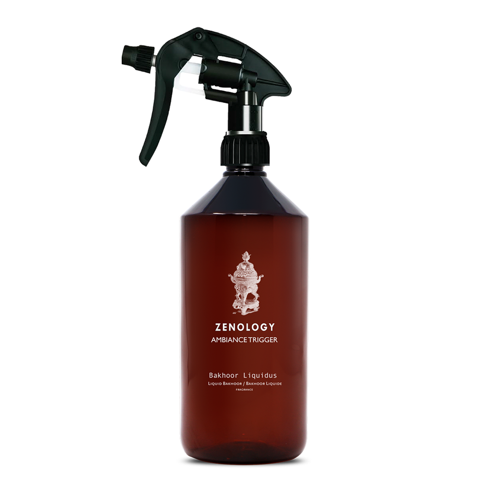 A large sized brown spray bottle labeled Zenology Ambiance Trigger Bakhoor Liquidus featuring an unique botanical illustration with a black spray nozzle.