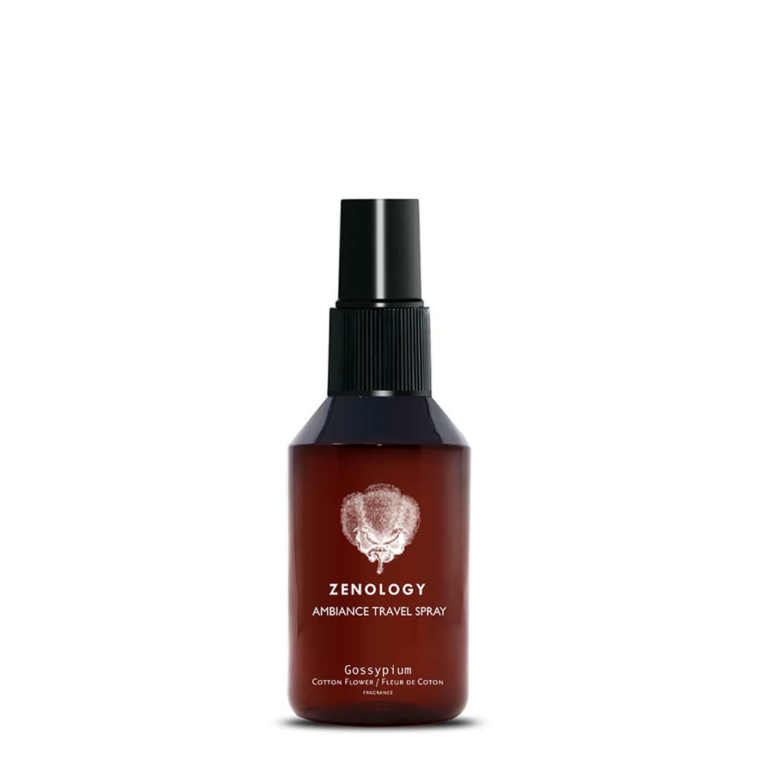 A small sized brown spray bottle labeled Zenology Ambiance Travel Spray Gossypium featuring an unique botanical illustration with a black spray top.