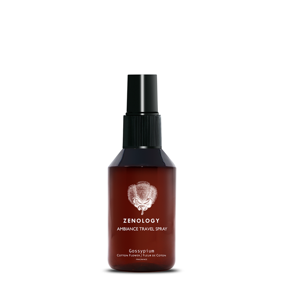 A small sized brown spray bottle labeled Zenology Ambiance Travel Spray Gossypium featuring an unique botanical illustration with a black spray top.