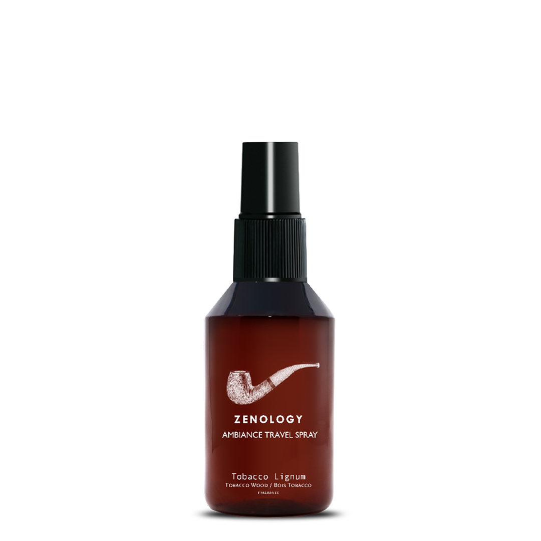 A small sized brown spray bottle labeled Zenology Ambiance Travel Spray Tobacco Lignum featuring an unique botanical illustration with a black spray top.
