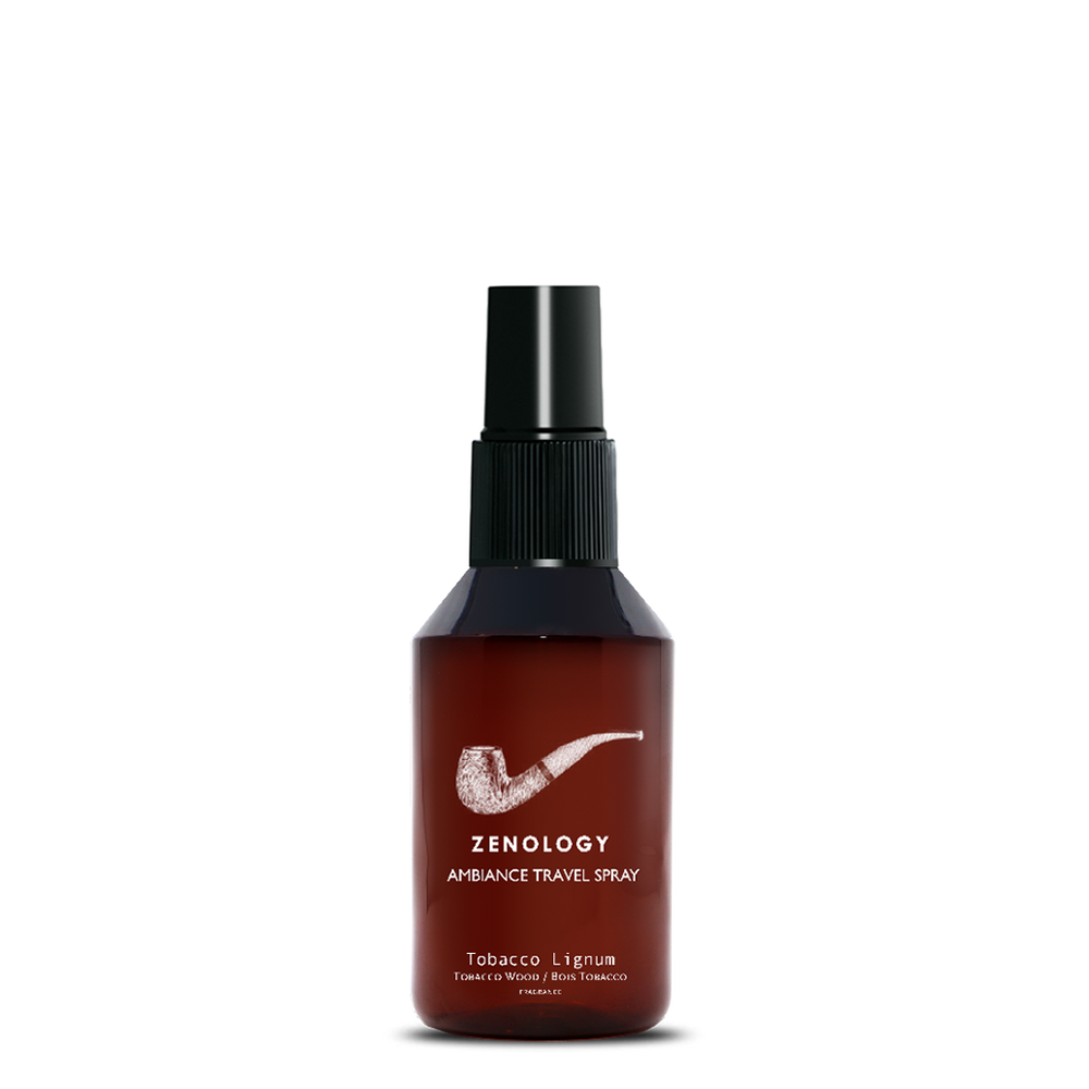 A small sized brown spray bottle labeled Zenology Ambiance Travel Spray Tobacco Lignum featuring an unique botanical illustration with a black spray top.