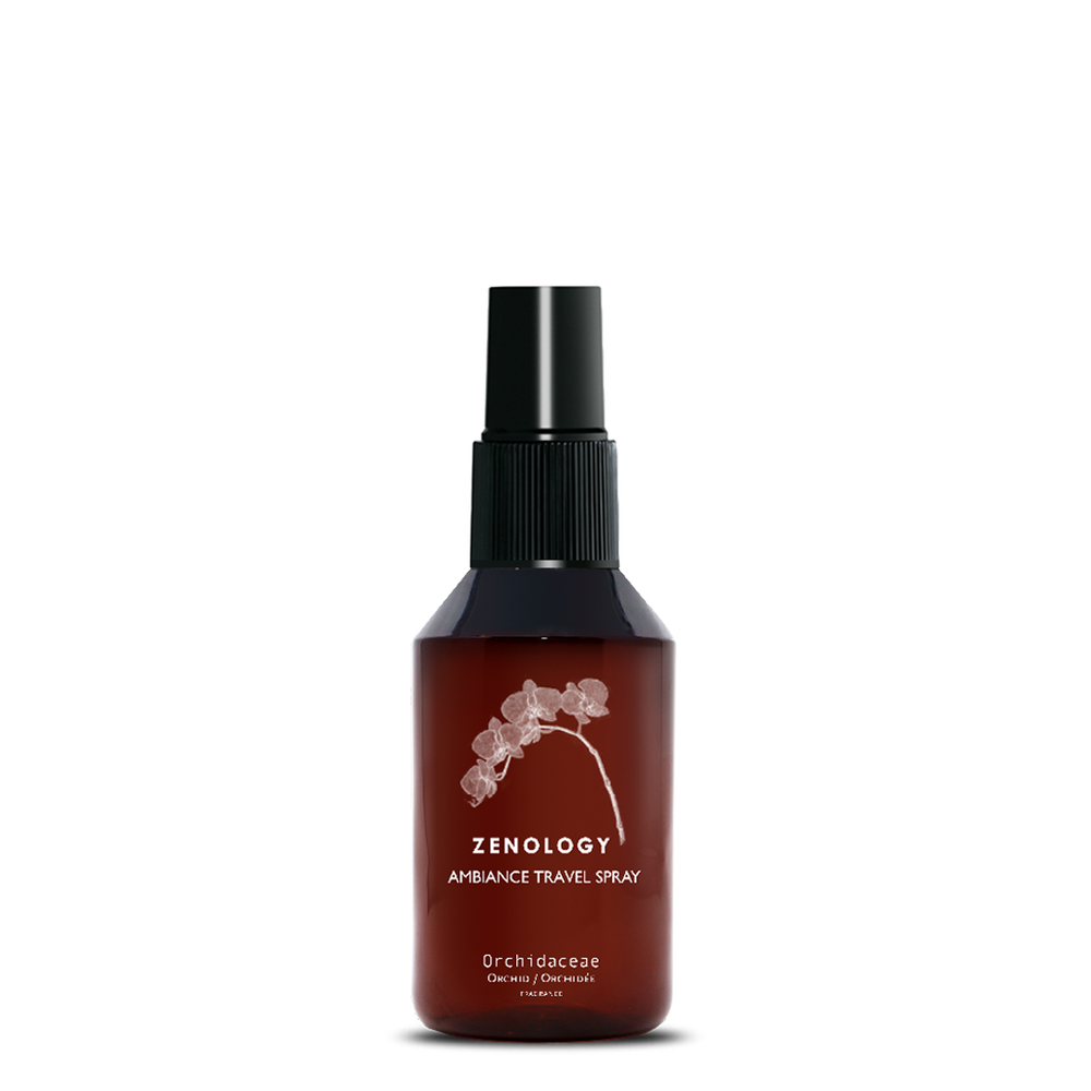A small sized brown spray bottle labeled Zenology Ambiance Travel Spray Orchidaceae featuring an unique botanical illustration with a black spray top.