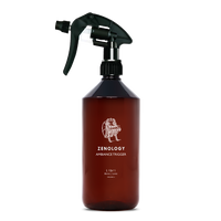 A large sized brown spray bottle labeled Zenology Ambiance Trigger Libri featuring an unique botanical illustration with a black spray nozzle.