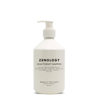 A white pump bottle labeled Zenology Scalp Therapy Shampoo Mandora & Palo Santo with a white pump.