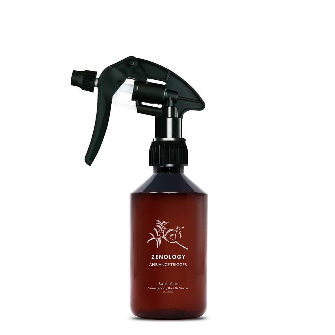 A mid sized brown spray bottle labeled Zenology Ambiance Trigger Santalum featuring an unique botanical illustration with a black spray nozzle.