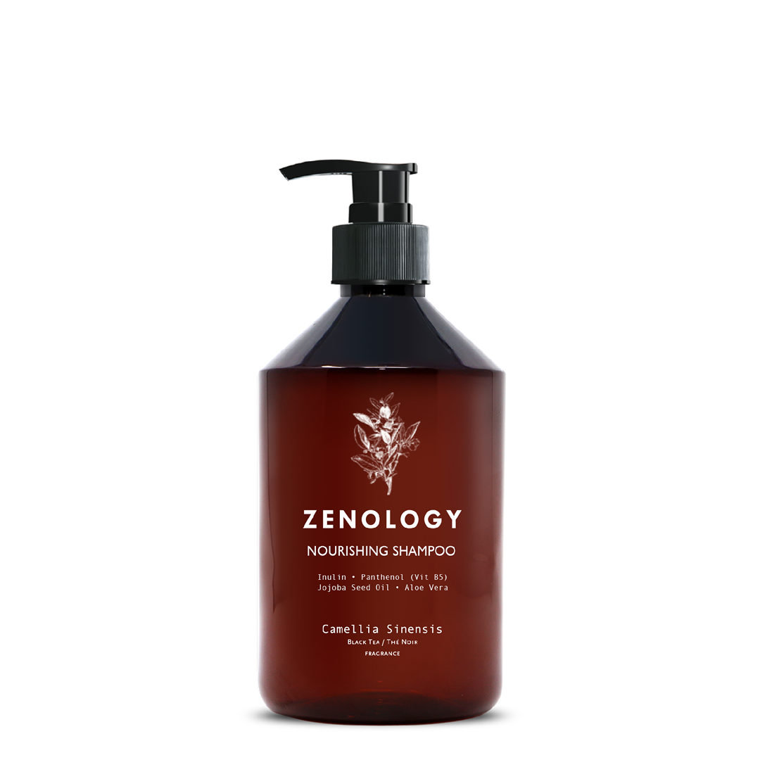 A brown pump bottle labeled Zenology Nourishing Shampoo Camellia Sinensis featuring an unique botanical illustration and a black pump.