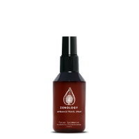 A small sized brown spray bottle labeled Zenology Ambiance Travel Spray Fycus Sycomorus featuring an unique botanical illustration with a black spray top.