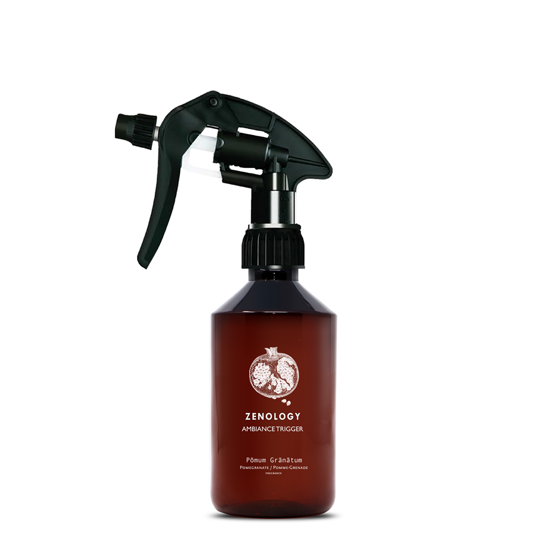 A mid sized brown spray bottle labeled Zenology Ambiance Trigger Pōmum Grānātum featuring an unique botanical illustration with a black spray nozzle.