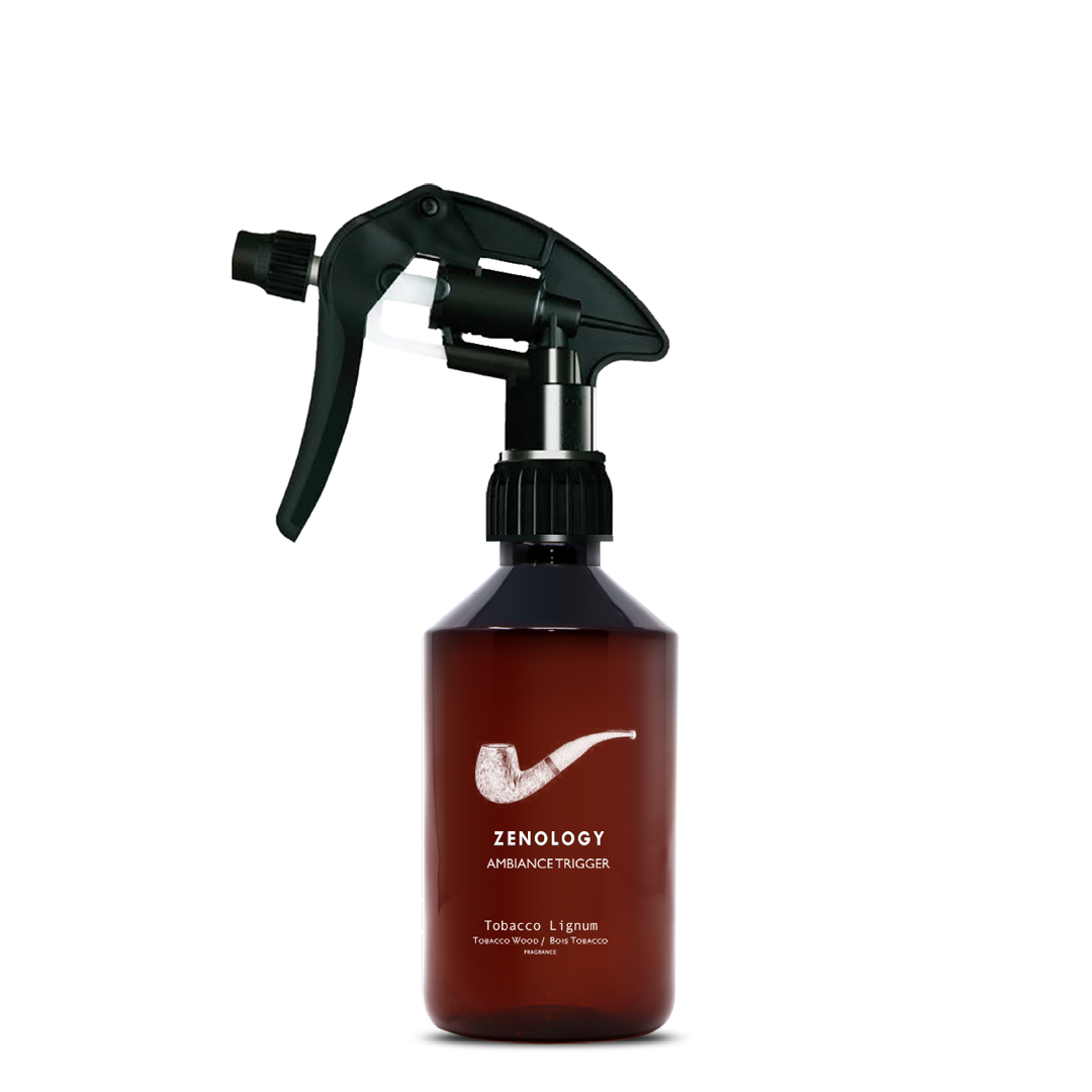 A mid sized brown spray bottle labeled Zenology Ambiance Trigger Tobacco Lignum featuring an unique botanical illustration with a black spray nozzle.