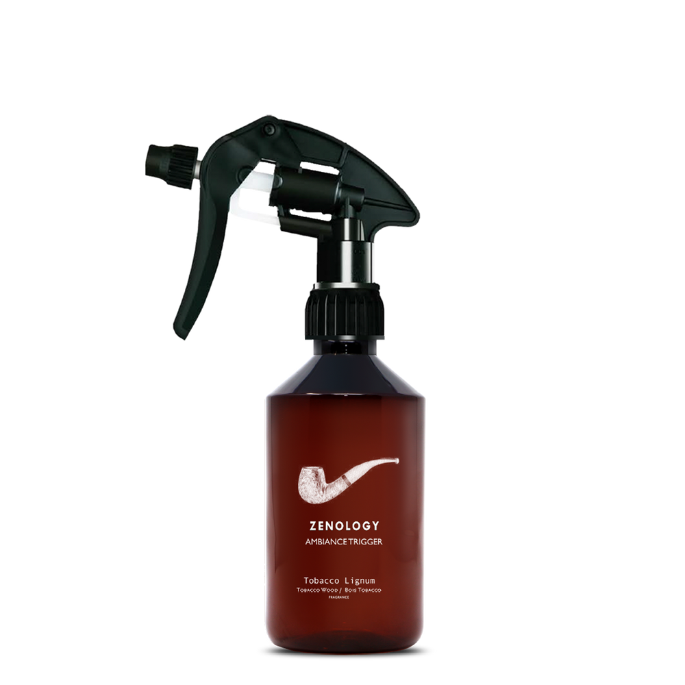 A mid sized brown spray bottle labeled Zenology Ambiance Trigger Tobacco Lignum featuring an unique botanical illustration with a black spray nozzle.