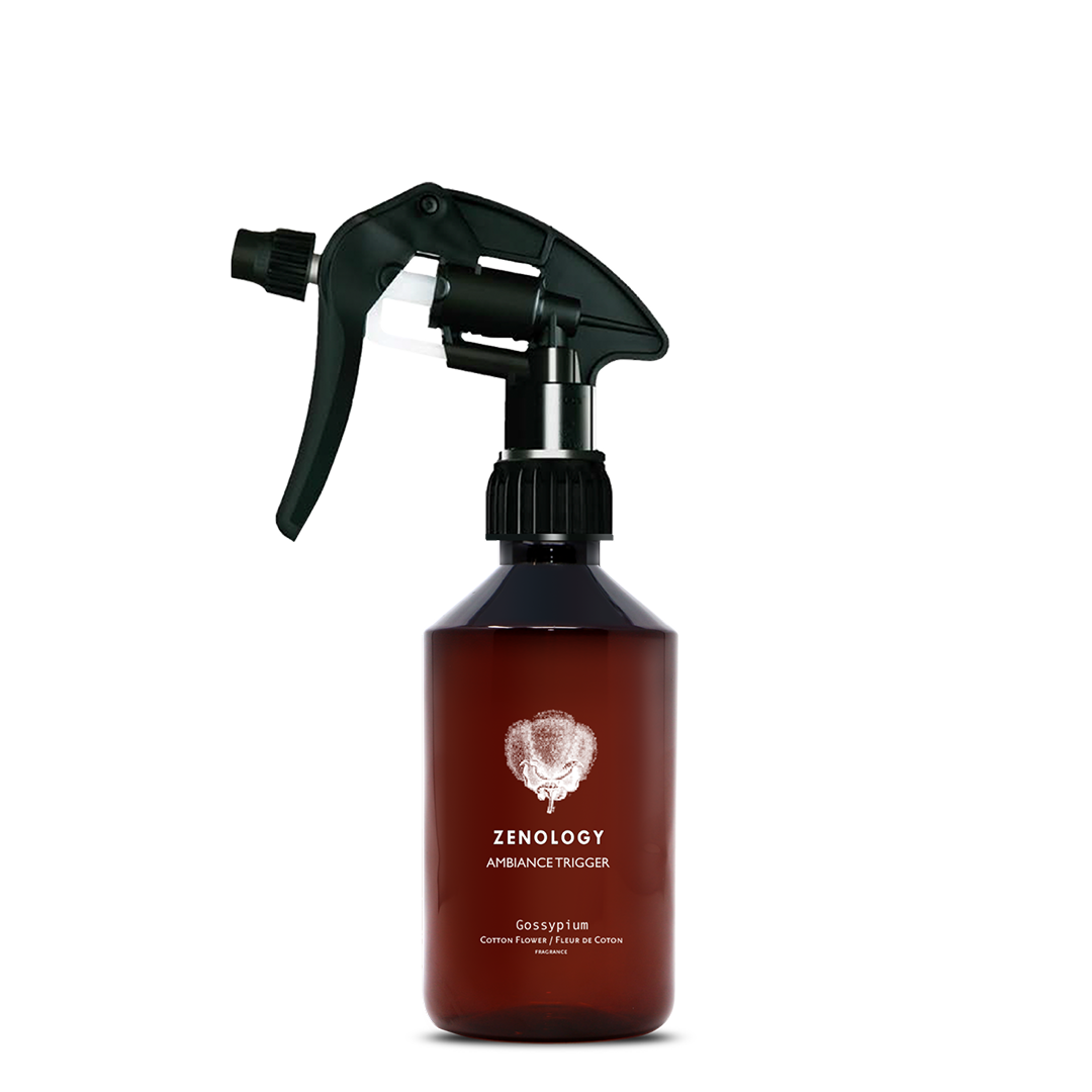 A mid sized brown spray bottle labeled Zenology Ambiance Trigger Gossypium featuring an unique botanical illustration with a black spray nozzle.