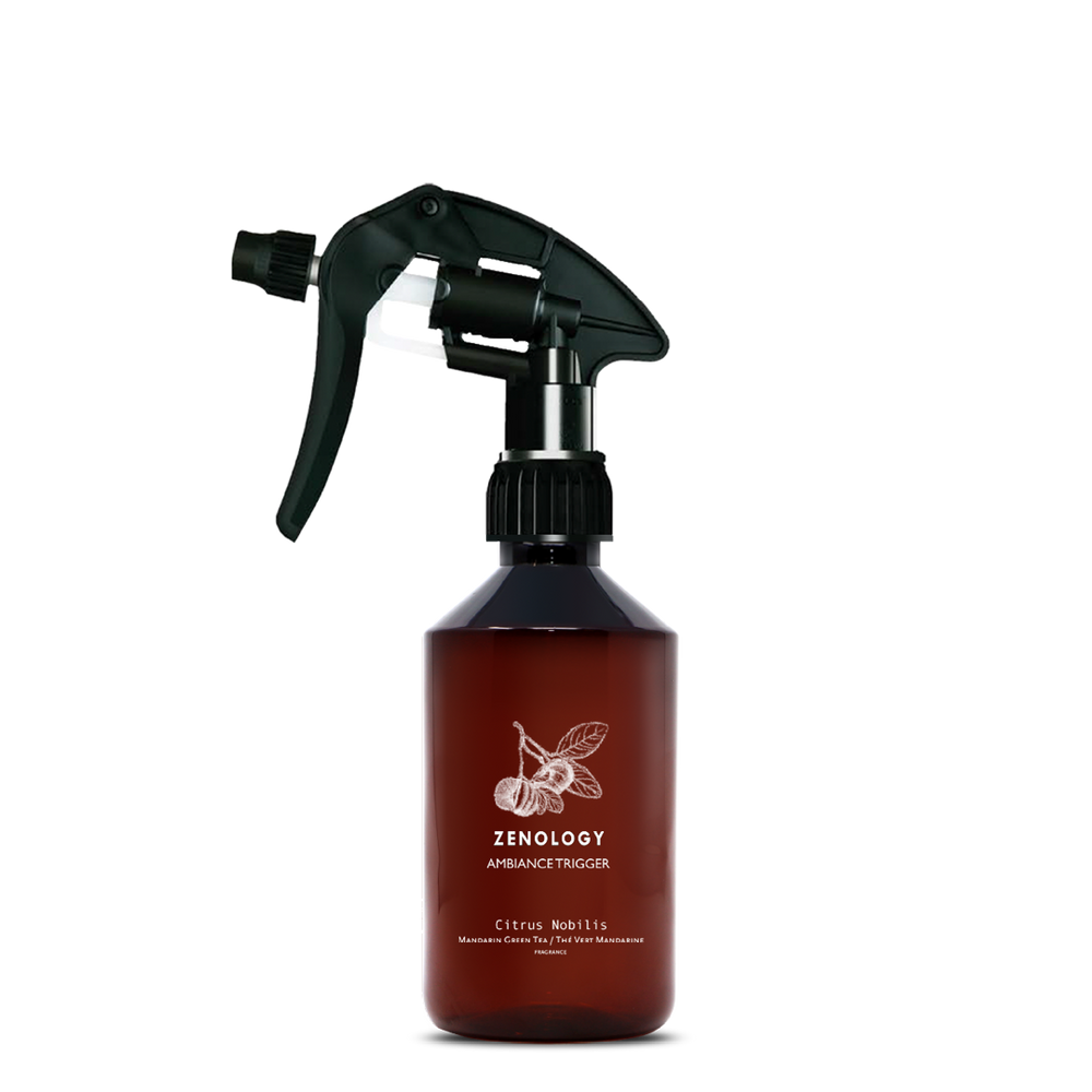 A mid sized brown spray bottle labeled Zenology Ambiance Trigger Citrus Nobilis featuring an unique botanical illustration with a black spray nozzle.