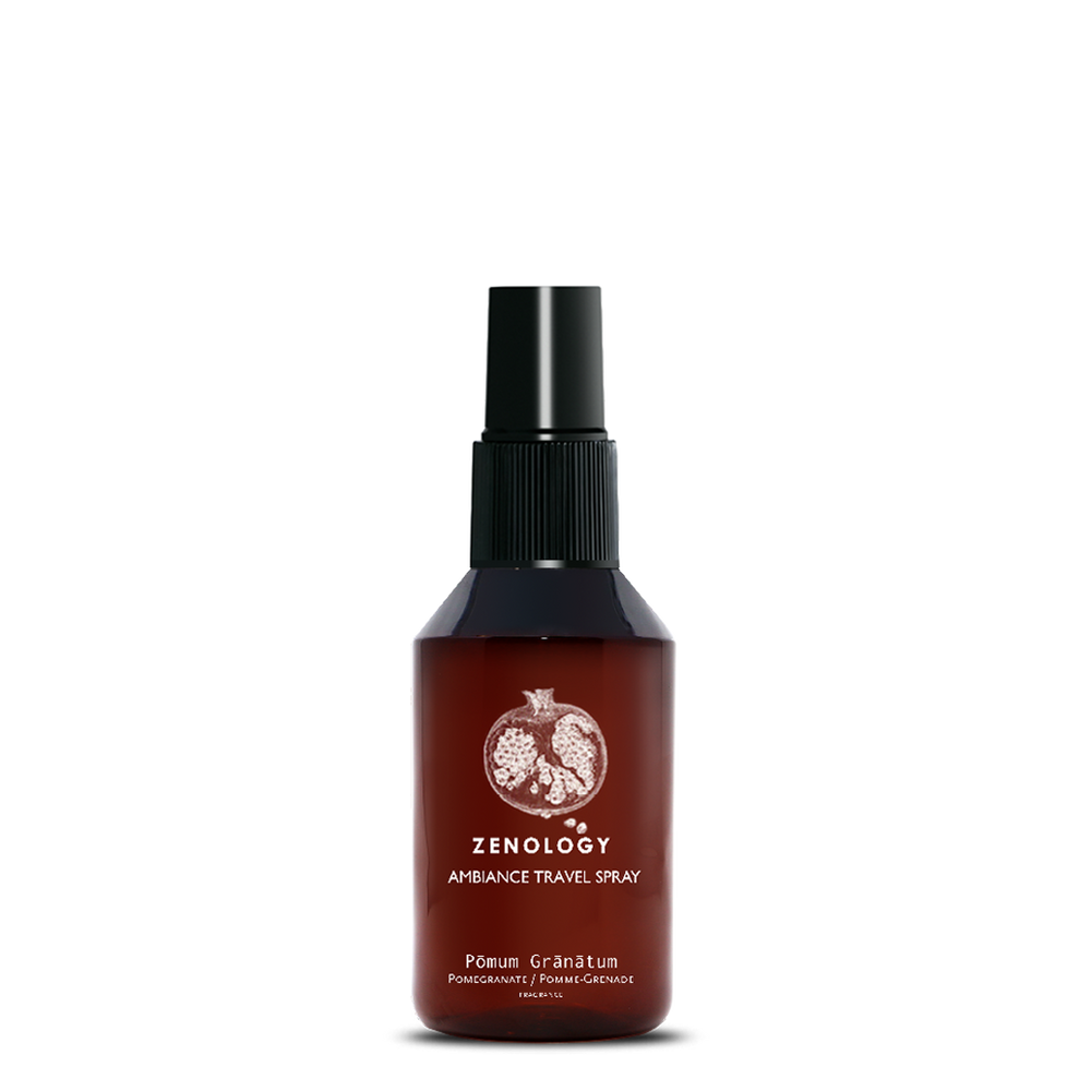 A small sized brown spray bottle labeled Zenology Ambiance Travel Spray Pōmum Grānātum featuring an unique botanical illustration with a black spray top.