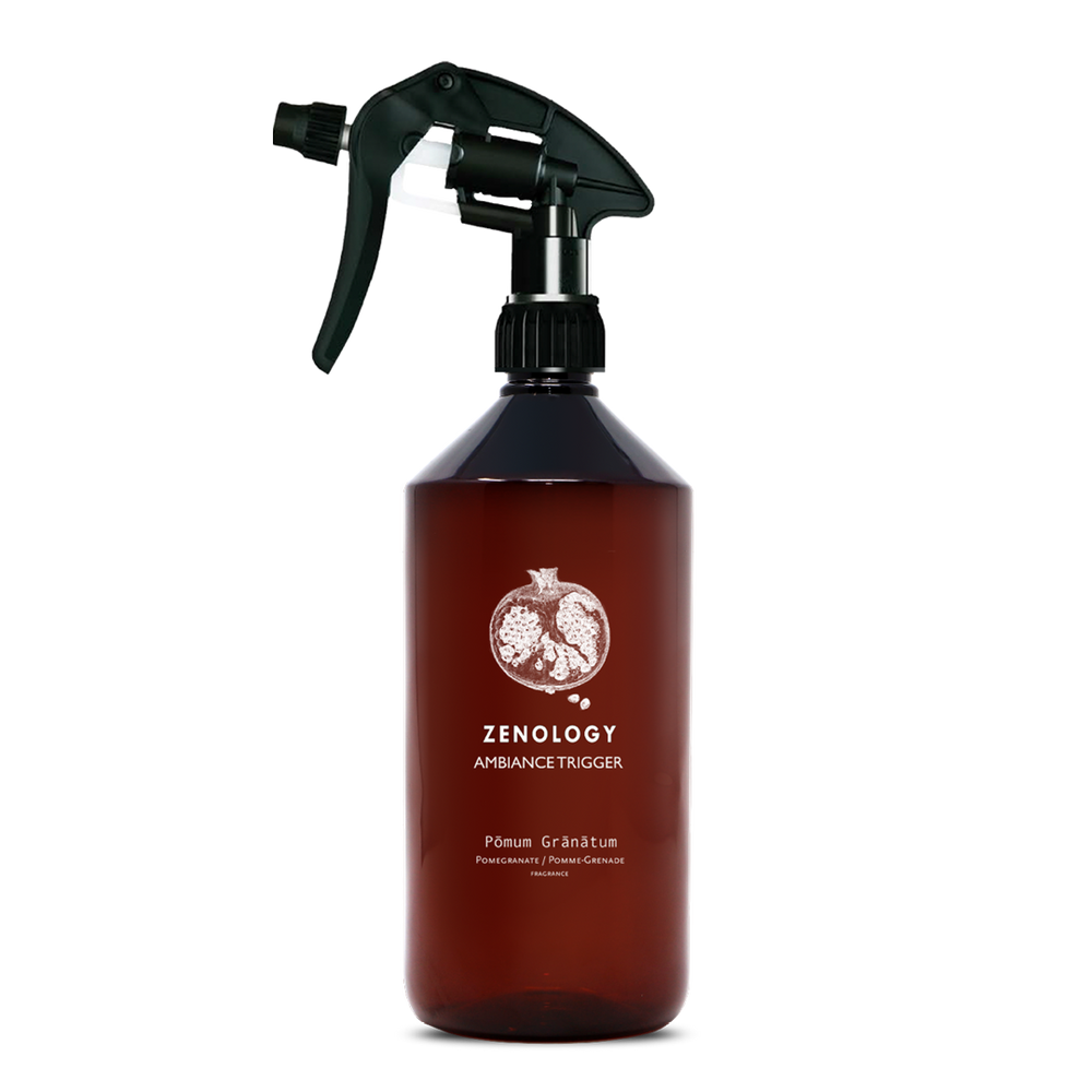 A large sized brown spray bottle labeled Zenology Ambiance Trigger Pōmum Grānātum featuring an unique botanical illustration with a black spray nozzle.