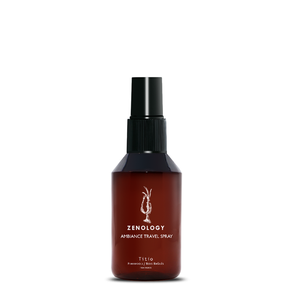 A small sized brown spray bottle labeled Zenology Ambiance Travel Spray Titio featuring an unique botanical illustration with a black spray top.