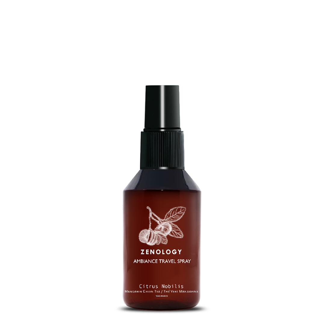 A small sized brown spray bottle labeled Zenology Ambiance Travel Spray Citrus Nobilis featuring an unique botanical illustration with a black spray top.