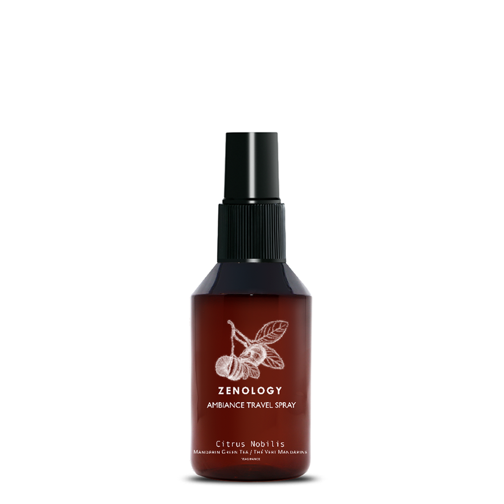 A small sized brown spray bottle labeled Zenology Ambiance Travel Spray Citrus Nobilis featuring an unique botanical illustration with a black spray top.