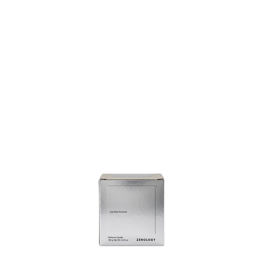 Camellia Sinensis perfume candle in its aluminium container beside the presentation box, shown from the front.