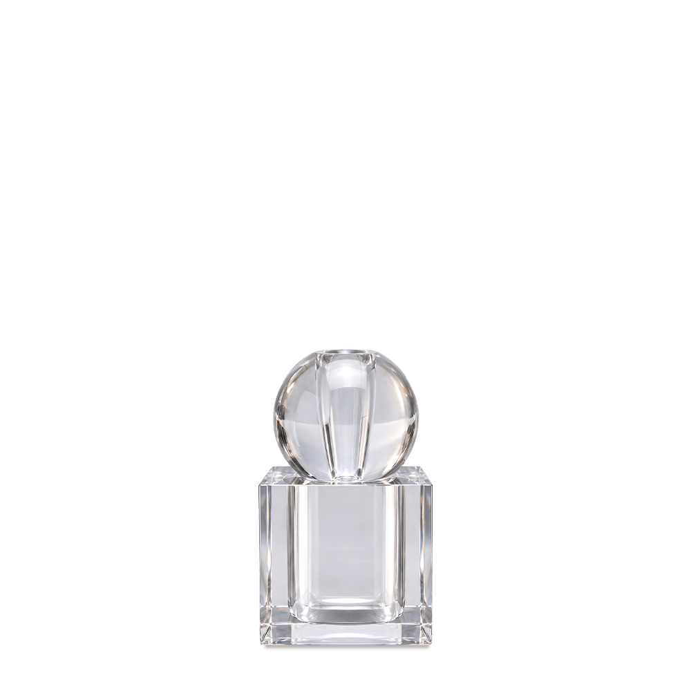Crystal perfume diffuser with faceted glass sphere and square crystal bottle, on a dark teal background.