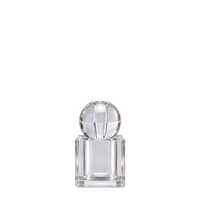 Crystal perfume diffuser with faceted glass sphere and square crystal bottle, on a dark teal background.